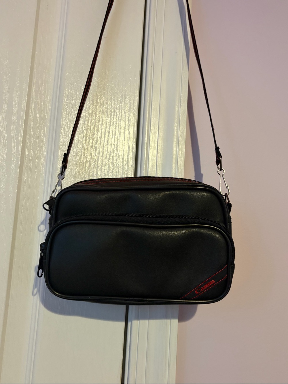 Vintage Canon Leather Black Crossbody Bag with Red Accent